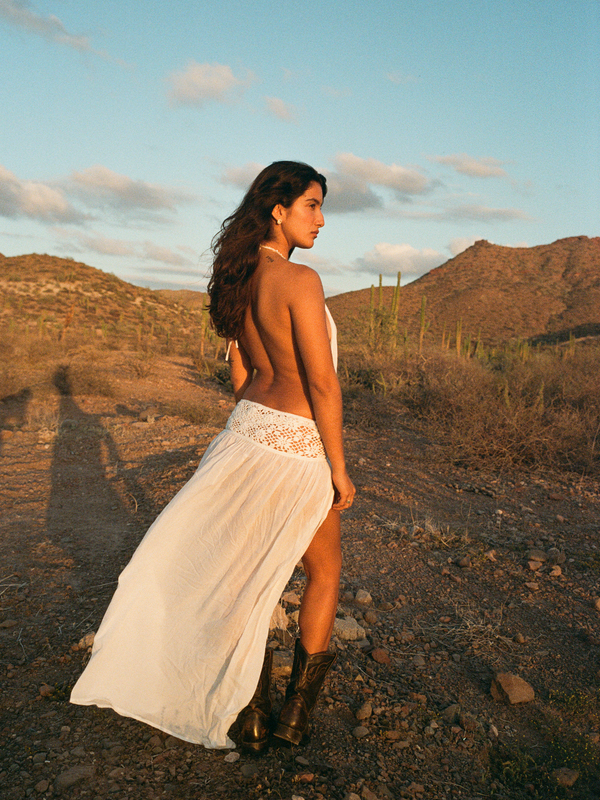 Model wearing the Loretta Dress white Lyocell maxi dress in the wild